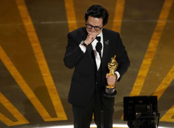 Ke Huy Quan reacts as he accepts the award for best performance by an actor in a supporting role for 