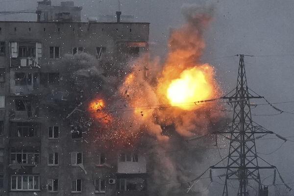 An explosion in an apartment building that came under fire from a Russian army tank in Mariupol, Ukraine on March 11, 2022. Picture: AP Photo/Evgeniy Maloletka